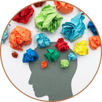 Silhouette of head with colored crumples of paper over top - representing cognitive bias