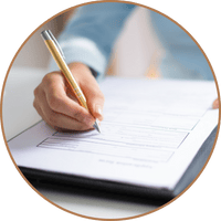 Someone reviewing and marking up documents on a desk, representing the importance of documenting business transition agreements