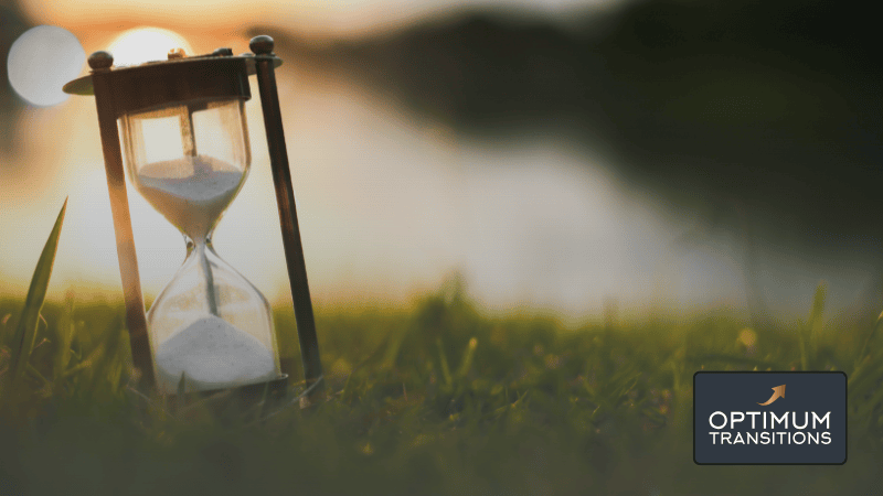 Hourglass with sand halfway through on a green lawn background, representing time-sensitive tax deadline information