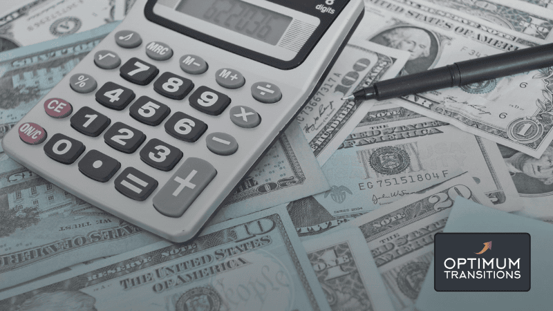 Calculator, pen, and cash arranged to represent the financial calculations and choices involved in financing a business sale