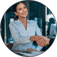 An advisor shakes hands with her client